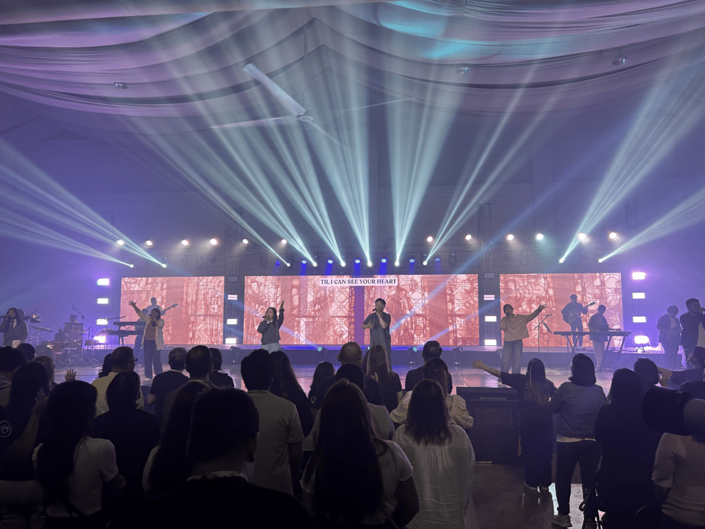 A live worship session at a large indoor venue