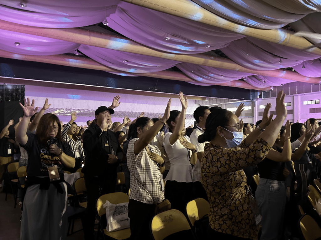 Attendees preaching in an enclosed space.