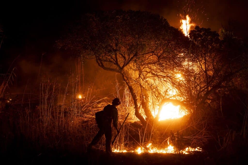 Fire tornadoes are a risk under California's extreme wildfire conditions. A firefighter monitors the spread of the Auto Fire in Oxnard, northwest of Los Angeles, California, on January 13, 2025. US officials warned "dangerous and strong" winds were set to push deadly wildfires further through Los Angeles residential areas January 12 as firefighters struggled to make progress against the flames. | Photo by ETIENNE LAURENT / AFP