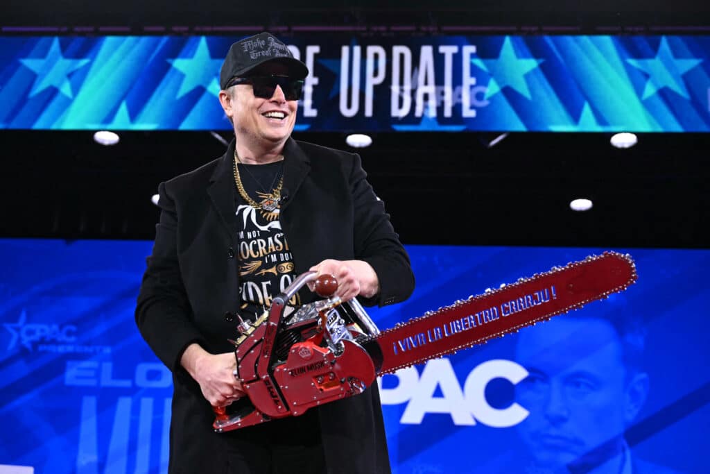 Elon Musk holds a chainsaw reading "Long live freedom, damn it" during the annual Conservative Political Action Conference (CPAC) at the Gaylord National Resort & Convention Center at National Harbor in Oxon Hill, Maryland, on February 20, 2025. The chainsaw was a present to Elon Musk from Argentina's President Javier Milei. (Photo by SAUL LOEB / AFP)