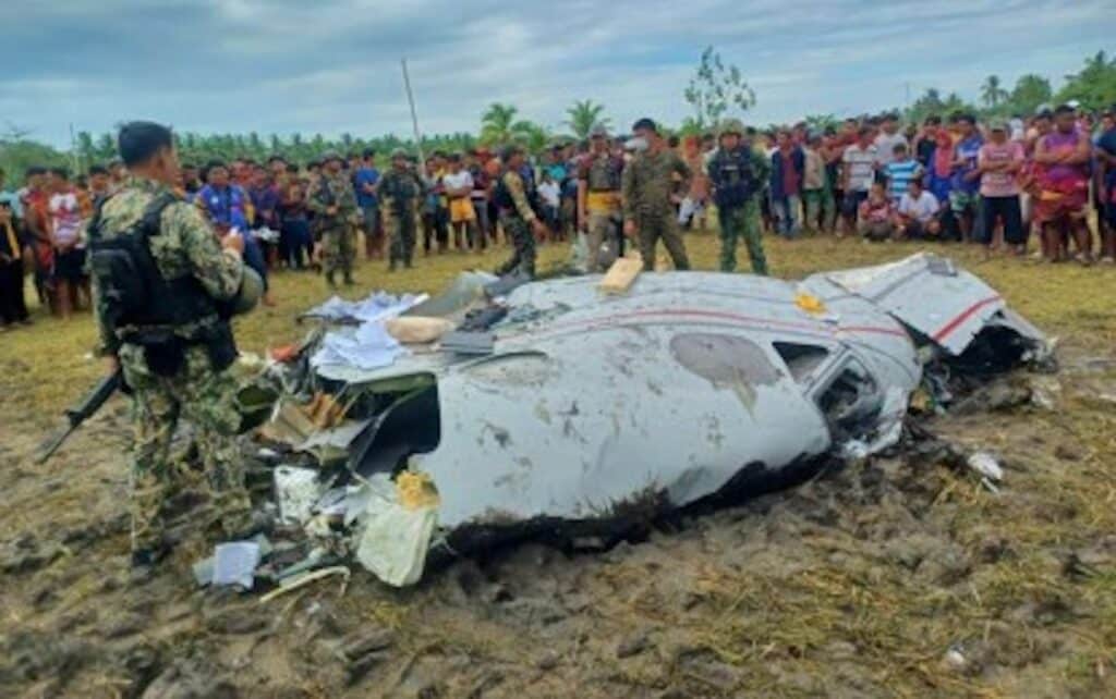 CRASH SITE. Police and military personnel inspect the wreckage of a Beechcraft King Air 300 (registration number N349CA) that crashed in Ampatuan, Maguindanao del Sur on Thursday (Feb. 6, 2025), killing all four passengers on board. Villagers gathered near the site as authorities conducted their investigation. (Photo courtesy of Bhengs B. Salinogen)