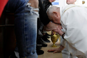 Pope, looking strong, washes, kisses feet of 12 women inmates on Holy Thursday. In photo Pope Francis kisses the foot of an inmate at Casal del Marmo juvenile prison during his visit for a foot washing service, in Rome, Italy April 6, 2023. | Reuters